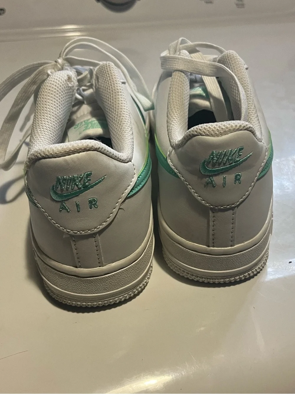 Nike White Sneakers with Light Green Swoosh Accent